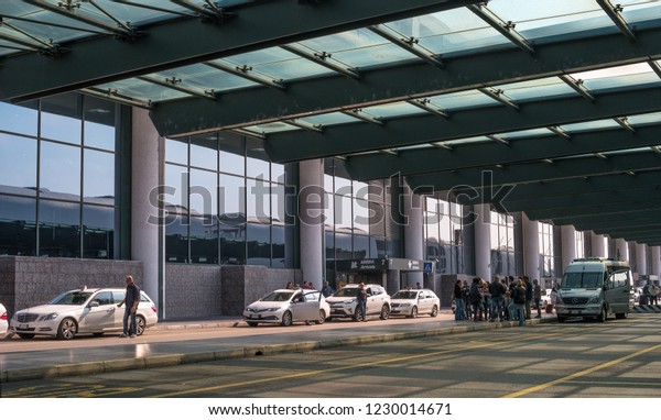 Malpensa airport, Italy - 18 October 2018: Taxi\
at Malpensa airport. Taxi waiting for passengers. White taxi\
airport parking