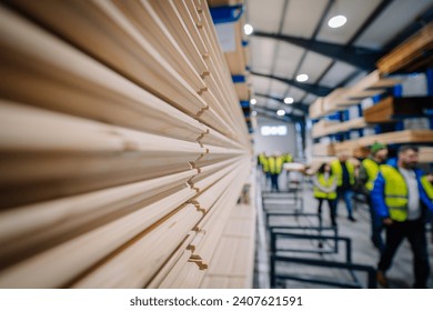 Malpils, Latvia, October 13, 2023 - warehouse or a lumber mill. The focus is on a stack of neatly arranged wooden planks extending towards the camera. 
