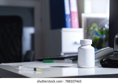 Malpractice, Bad Healthcare, Negligence, Medical Fraud Or Abuse Or Treatment Error Concept. Medicine Bottle On Table And Desk In Doctor Office In Hospital. Dramatic Lighting. Illegal Or Fake Doctor