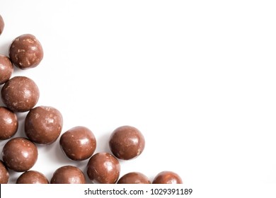 Malt Balls With Chocolate Shot Close Up On A White Background