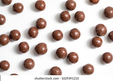 Malt Balls With Chocolate Shot Close Up On A White Background