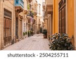 Malta, Birgu. Narrow street with stone buildings.