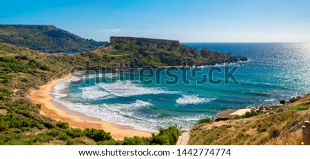 Maltese beach. Seashore of Malta. Ghajn tuffieha bay in summer. Tropical resort. Landscape with beach and clear sky.