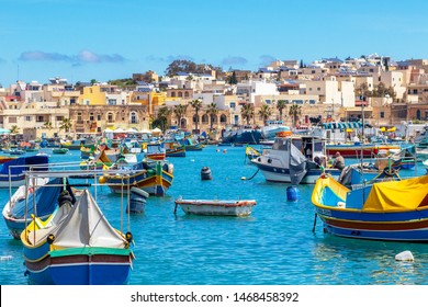 Maltese boats float in the harbor of Marsaxlokk, Malta. the fishing boats are decorated with the eye of Osiris to keep the fishers safe at sea