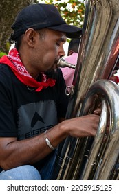 Maluku, Indonesia - September 24, 2022: A Man Playing A Bass Trumpet