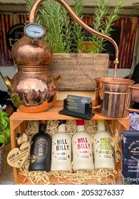 Malvern, England, UK-September, 25, 2021: Small Copper Gin Distiller And Bottles With Gin. Selective Focus  