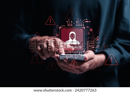 Malware attack virus alert. Ransomware malware attack and data breach. Person use smartphone with virtual warning sign with ransomware word. warning notification, Cyber threats.
