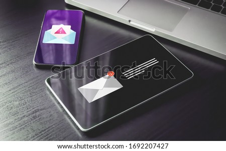 Malware Spreading Virus, Spam Distribution - smartphone and tablet pc with mail notification alert and warning message icon. Irrelevant unsolicited malicious software, scam, fraud e-mail concept