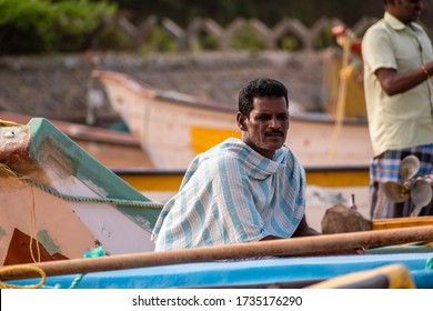 Mamallapuram, Tamil Nadu, India - August 2018: A Candid Portrait Of A Fisherman Sitting In His Fishing Boat On The Mahabalipuram Beach.