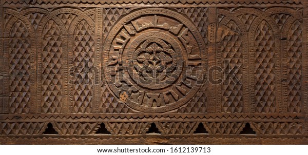 Mamluk era style wooden engraved wall decorated\
with floral and geometric\
patterns