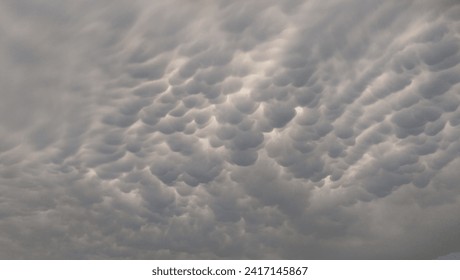 Mammatus clouds with light inbetween