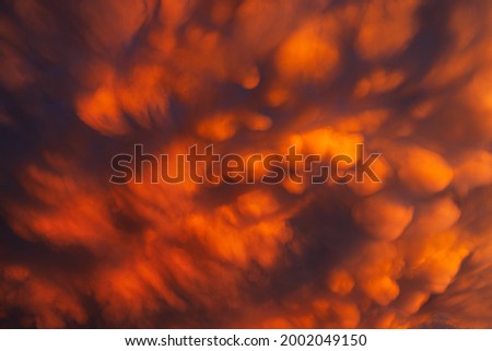 Mammatus clouds in the stormy sky. An unusual phenomenon