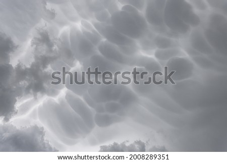 Mammatus storm clouds. Mammatus thunder clouds making an ideal stormy background.
