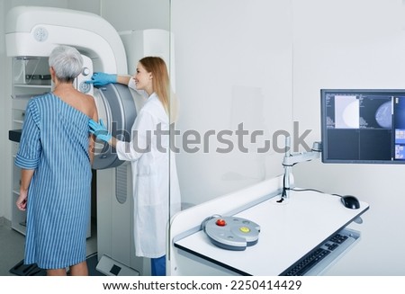 Mammography procedure, breast cancer prevention.Mature woman getting breast screening or mammography scan at medical clinic with mammologist [[stock_photo]] © 