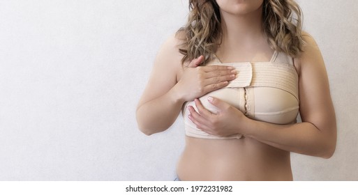 Mammoplasty Young Woman In Beige Compression Bra Bandage After Breast Augmentation Surgery Mammoplasty. Banner. Advertising. Copy Space