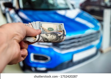  Man with 100 dollar banknotes money near car. Buy or rent a new auto. Finance concept - Shutterstock ID 1752420287