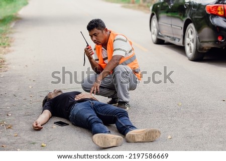man accident lay down unconscious on the road hit by car during playing phone emergency team staff radio for help