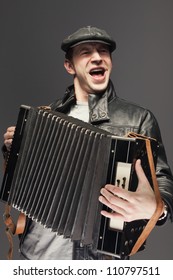 Man with accordion. Man is singing songs and playing the old accordion - Shutterstock ID 110797511