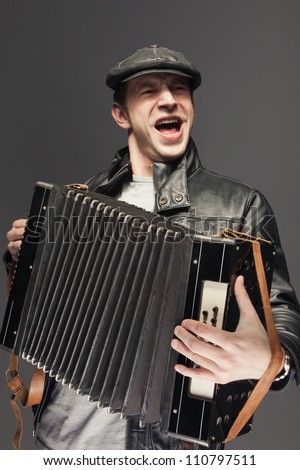 Man with accordion. Man is singing songs and playing the old accordion