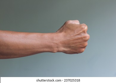 Man is acting in the fighting pose, right fist ready to fight - Shutterstock ID 237025318