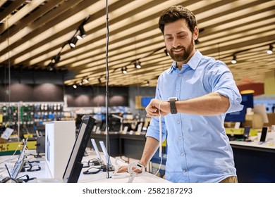A man is actively exploring a diverse range of smartwatches displayed in a vibrant and exciting electronics store, showcasing the latest cuttingedge technology and current shopping trends in retail