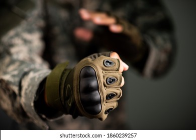 The man in ACU jacket wear green tactical gloves. - Powered by Shutterstock