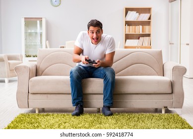 Man addicted to computer games - Shutterstock ID 592418774