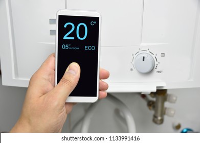 Man Adjusting Burner Temperature With A Phone
