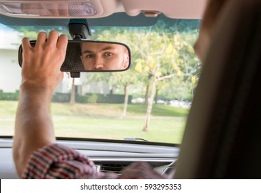 Man Adjusting His Car Mirror. 