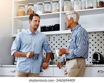 Man, advice and senior father in kitchen with conversation in morning with coffee for help or consult in retirement. Proud, dad and son on weekend together in home for family dinner in Switzerland. - Powered by Shutterstock