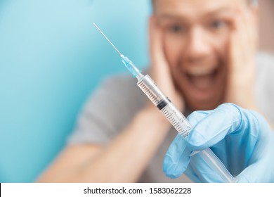 Man Is Afraid Of Nurse. Fear Of Syringe Injections And Vaccinations Doctor Appointment.