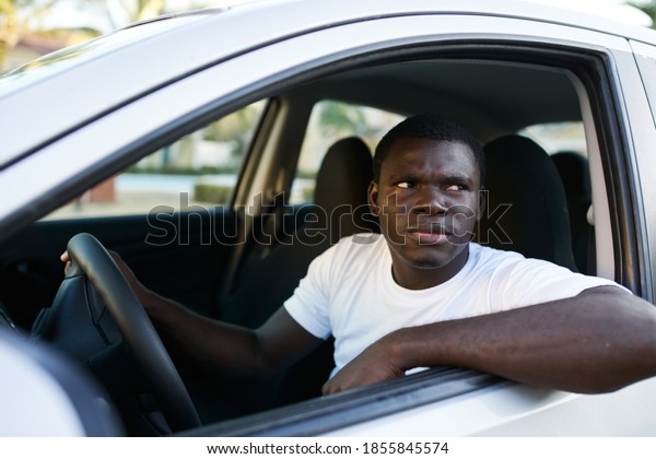 Man of\
African appearance I am driving a car\
trip