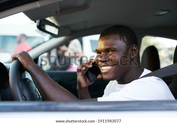 man african appearance driving a car trip\
communication by phone