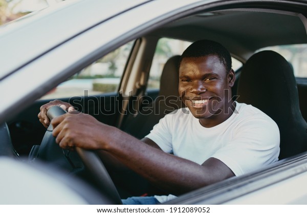 man african\
appearance driving a car smile\
ride