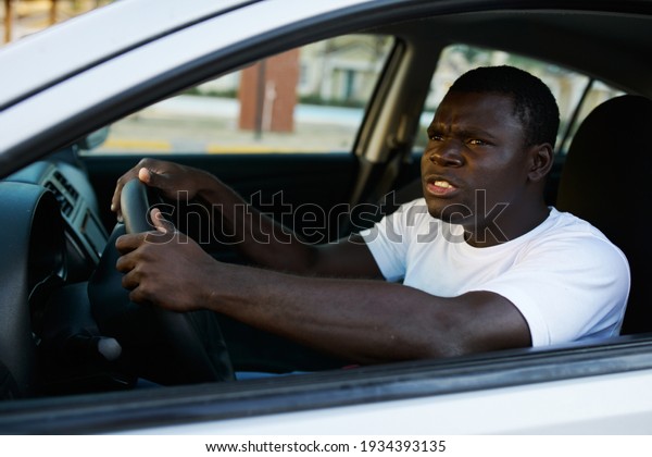 man of\
african appearance driving a car trip\
freedom