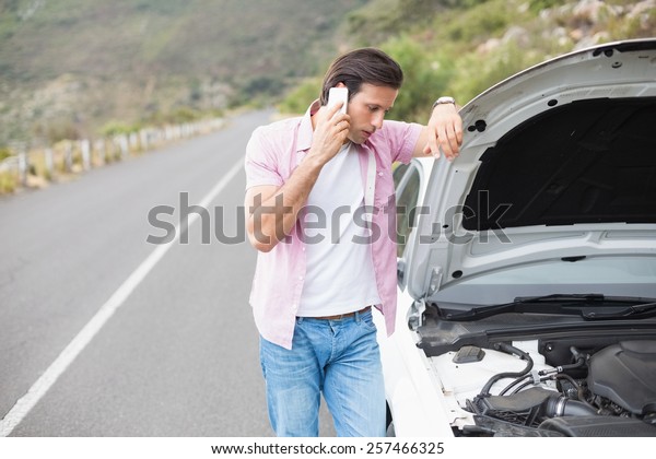 Man after a\
car breakdown at the side of the\
road