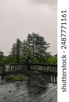 A man against the background of a green forest, an abandoned sanatorium in Tskaltubo