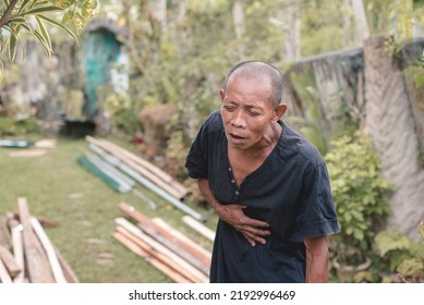 A man agonizing from severe stomach pain or intense hunger pangs. Suffering from indigestion or ulcers. - Shutterstock ID 2192996469
