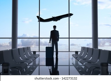 man in airport and airplane in sky