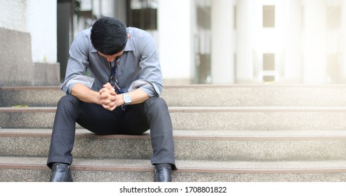 A Man Alone Sitting And Feel Sad Cause Of Unemployed Or Out Of Work, Economic Crisis