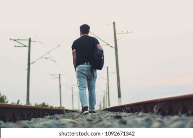 Man Alone Walking Away On The Railroad. Travel Background.