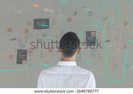 Man analyzing data on a digital screen. Data visualization, graphs, and charts. Business strategy insights. Male professional, data-driven analysis, tech interface. Photo of a man.