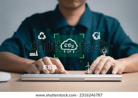 Man analyzing renewable energy data with virtual screen on computer, environment protection concept, ESG, energy saving pollution reduction target Green energy and environmentally friendly.