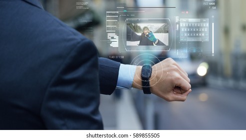 A man answers the wife who smiles and waves from the phone that appears in hologram clock futuristic and technological. Concept: network, communication,family, technology, augmented reality and future - Powered by Shutterstock