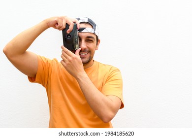 Man with antique camera. Man taking pictures with an antique camera.