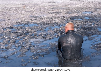 A Man Applies Healing Mud To His Body. Beneficial Effect On The Body And Skin. Healthcare. Salt And Mud From The Dead Sea