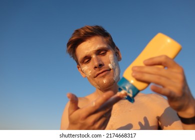 A Man Applies Sun Cream. Skin Care In The Summer Sun. Men's Skin Care And Protection From Burns. Male Using SPF Cosmetic. Skin Care After Sunbathing. Face Health For Man. 