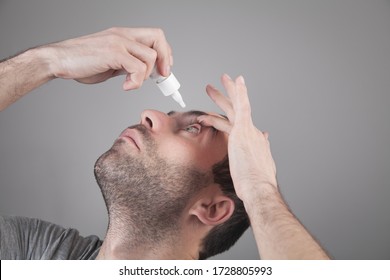 Man Applying Eye Drop To Eye. Artificial Tears