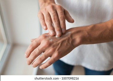 Man Applying Hand Cream, Closeup