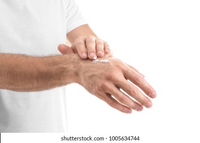 Man Applying Hand Cream On White Background, Closeup